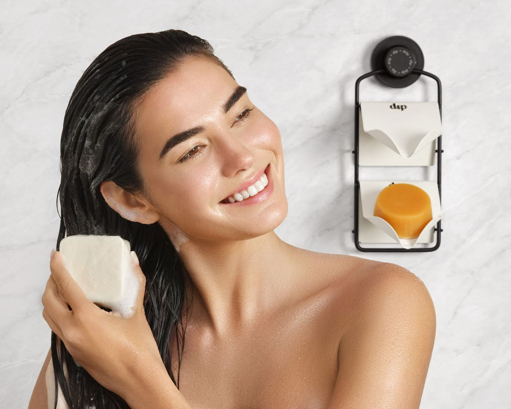 A person using Dip’s shampoo and conditioner bars after receiving them as self care gifts for women