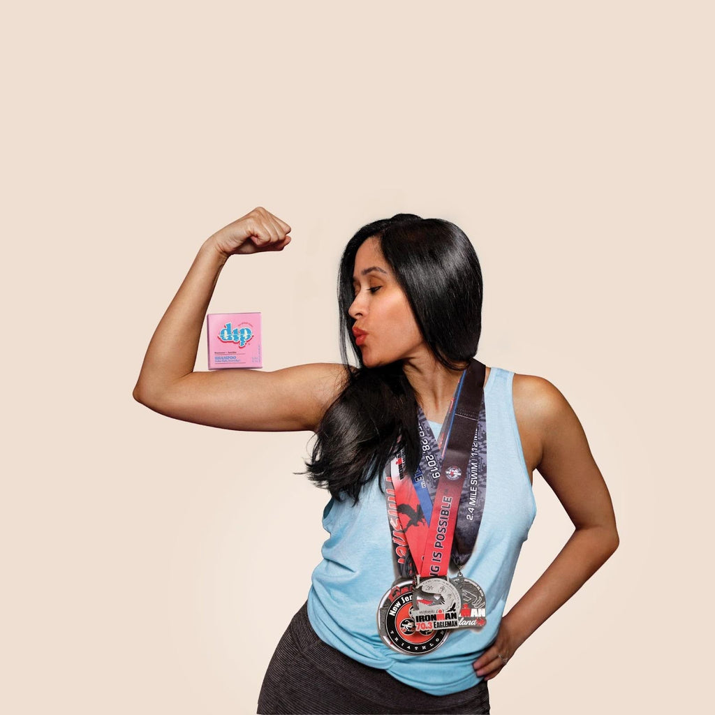 A running wearing her race medals, and showing off great hair, plus her Dip hair care bar.
